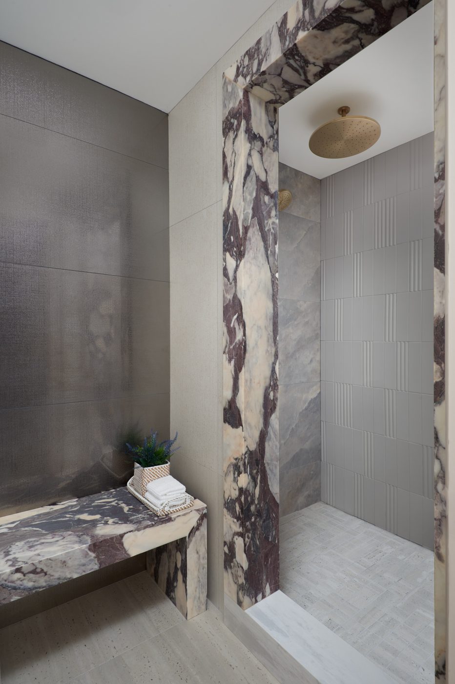 Marble accent wall and bench in a custom residential spa bathroom, York Downs renovation by Pro-Con Construction